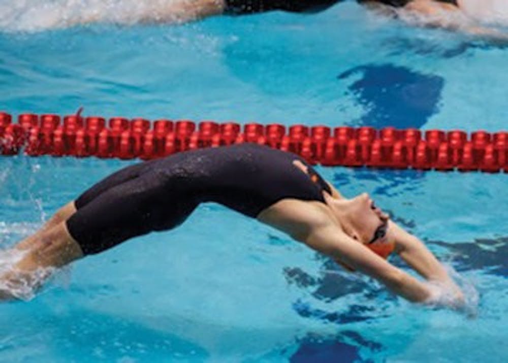 Aubrey Peacock in the 100m backstroke finals of the 2014 SEC Championships. (Inset) Peacock celebrates her victory in the consolation finals of the 2014 NCAA Championships, which earned her a ninth-place finish in her final collegiate race. (Contributed by Steve Peacock)