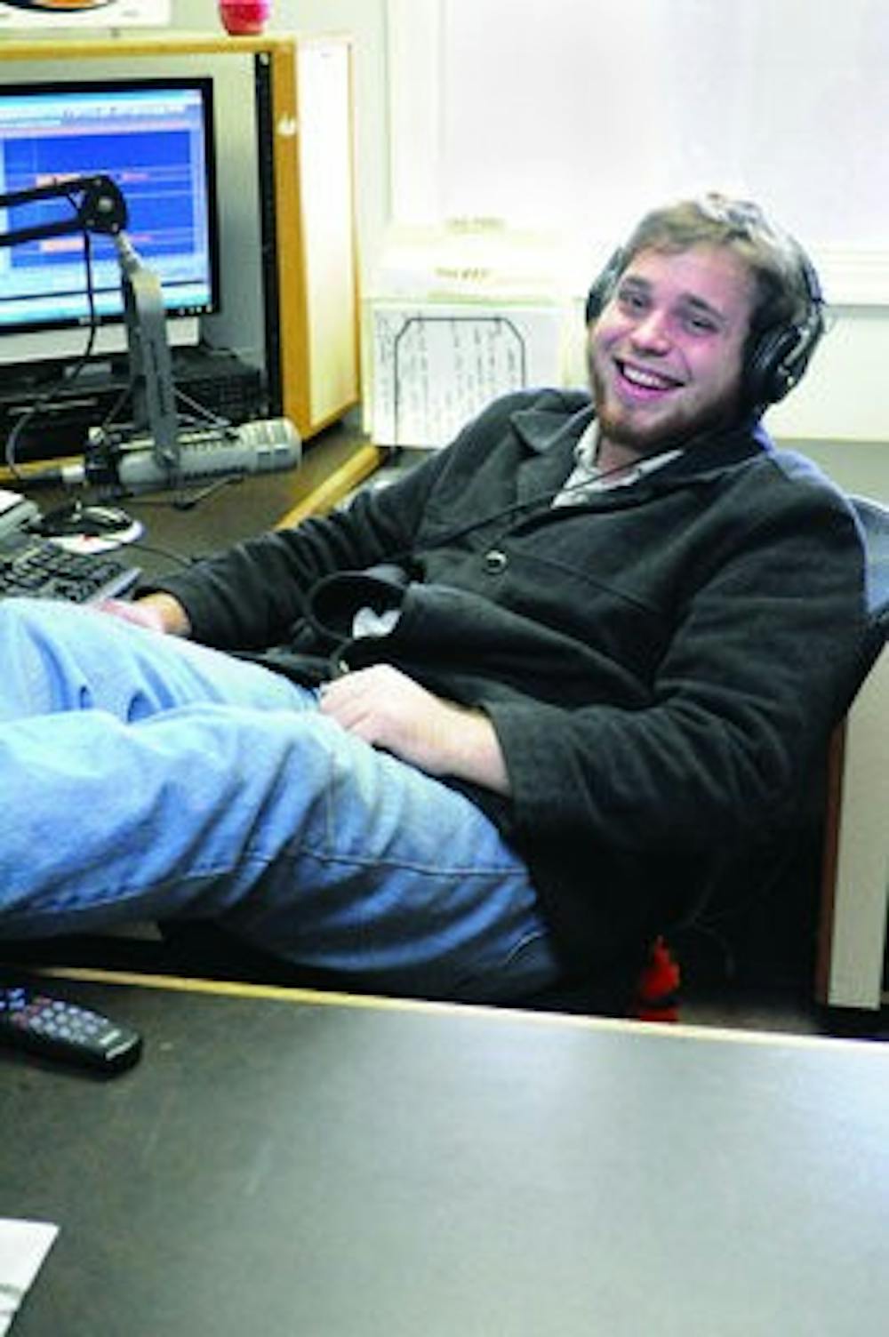 Mix 96.7's program director Donny Blankenship relaxes behind the mic. Blankenship also hosts the station's weekday morning show from 6-10 a.m. (Christen Harned / ASSISTANT PHOTO EDITOR)