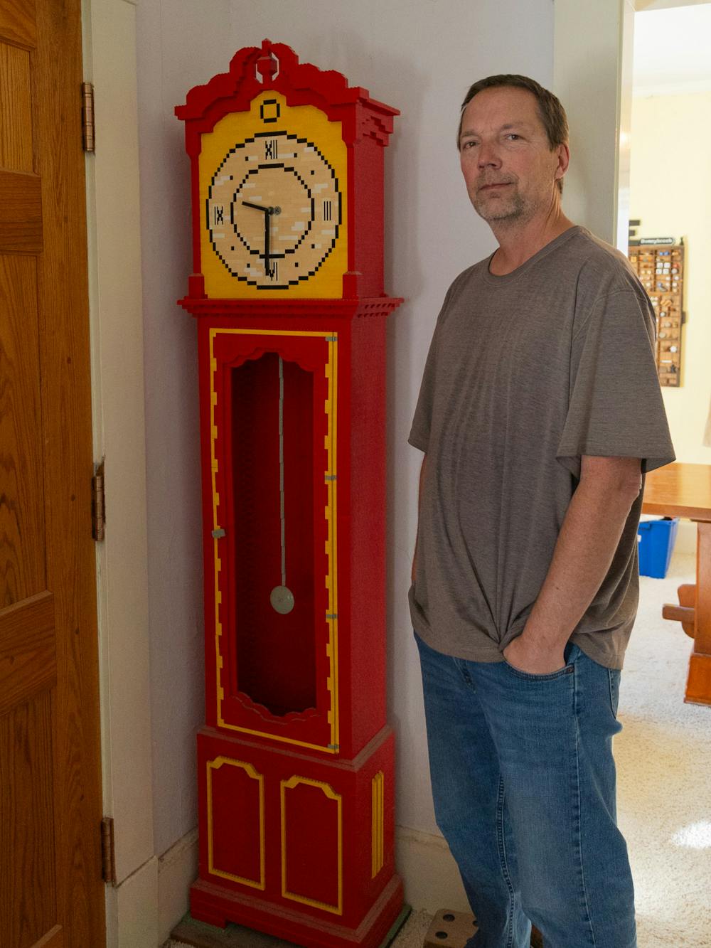 Professor Eric Harshbarger with his LEGO grandfather clock, which at one time was fully functional. 