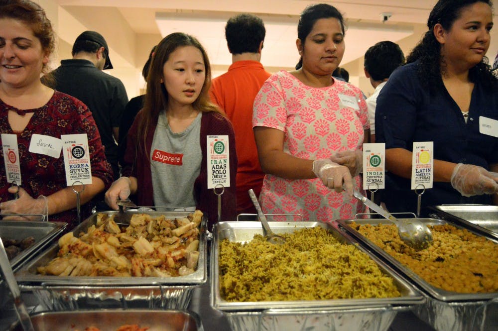 Volunteers serve food during the International Peace Dinner hosted by the International Student Organization in the Student Center on Oct. 28. 