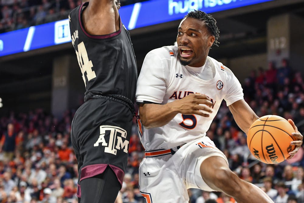Auburn basketball's Chris Moore (5) faces a Texas A&M defender in a matchup between the two teams in Neville Arena on Jan. 25, 2023.