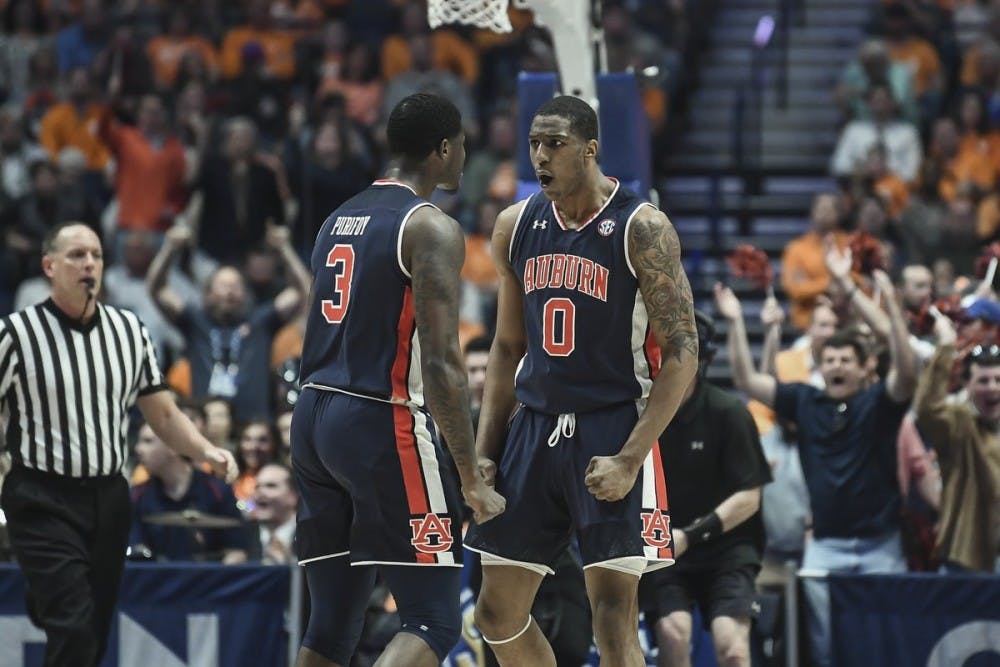 <p>Danjel Purifoy (3) and Horace Spencer (0) celebrate during Auburn basketball vs. Tennessee on March 17, 2019, in Nashville, Tennessee. Via @AuburnMBB on Twitter.</p>