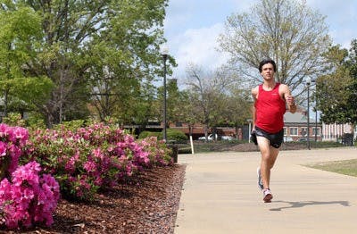 Tim Marquardt is training to run The Boston Marathon April 18. He runs 10 miles every day and has saved all of his previous racing numbers to decorate the walls of his room. (Emily Adams / PHOTO EDITOR)