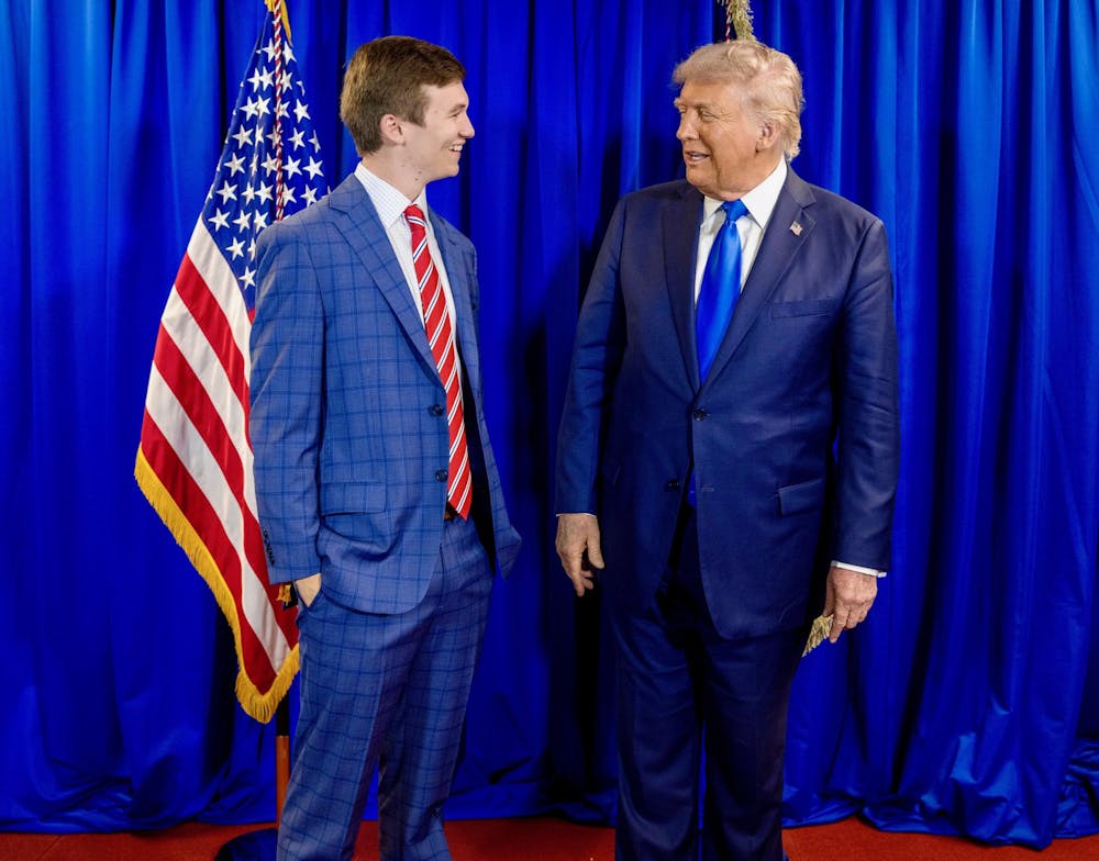 <p>Brilyn Hollyhand (Left) takes a photo with President Trump (Right) after Trump's graduation speech at the University of Alabama on May 1. </p>