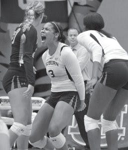 Senior outside hitter Sarah Bullock celebrates a point against Alabama. Auburn beat Alabama three sets to one, and Bullock scored her 1,000th career dig. The win over Alabama improved Auburn's record to 12-2, one more than the 2011 total wins. (Rebecca Croomes / PHOTO EDITOR)