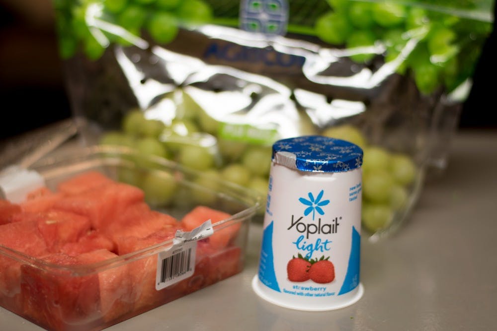 A container of yogurt, a box of watermelon chunks and a bag of grapes sit on a kitchen counter in Auburn, Ala., on Tuesday, March 6, 2018.
