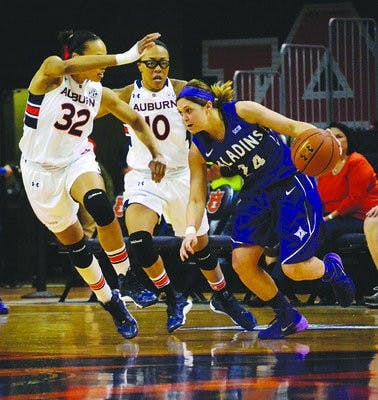 Tyrese Tanner and Brandi Montgomery closes out on Furman's Brigid Morrissey