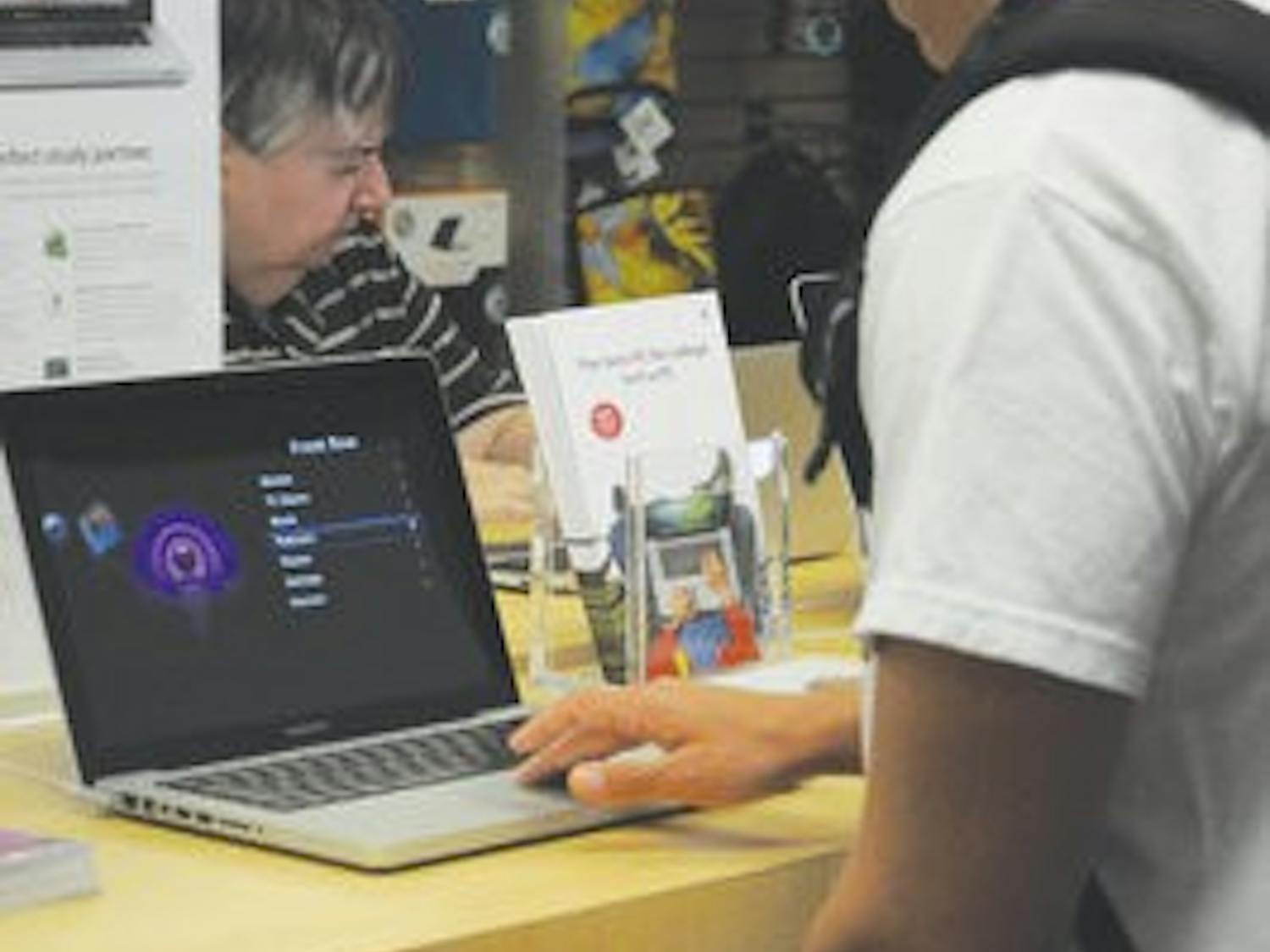 Jimmy Cooper, sophomore in supply chain and aviation management, looks at a computer in the Mac store on campus. (Christen Harned / ASSISTANT PHOTO EDITOR)