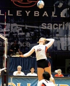 Junior Courtney McDonald sets up sophomore Halle Kearney for the spike against Mississippi State Friday, Oct. 5. (Emily Morris / ASSISTANT PHOTO EDITOR)