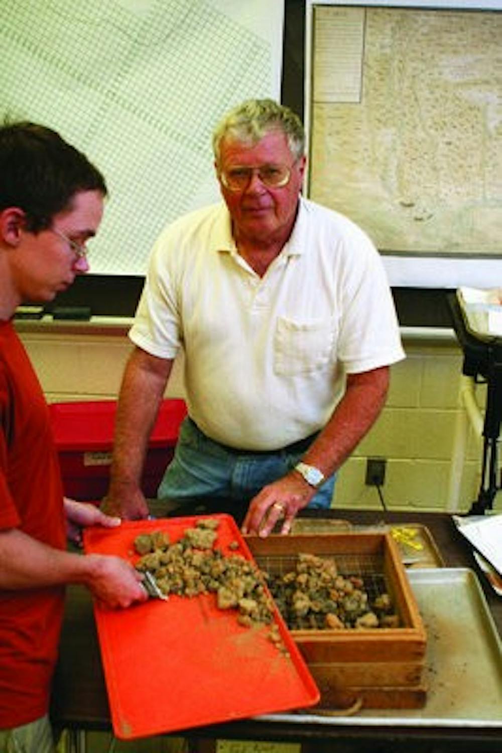 Professor John Cottier works with student assistant Hamilton Bryant, senior in anthropology, sifting through rocks in search of artifacts. (Rebecca Croomes / ASSISTANT PHOTO EDITOR)