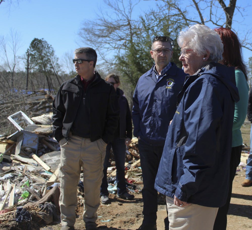 Gov. Kay Ivey looks out at damage surrounding Lee Road 38 during her tour of tornado damage on Wednesday, March 6, 2019, in Beauregard, Ala. 