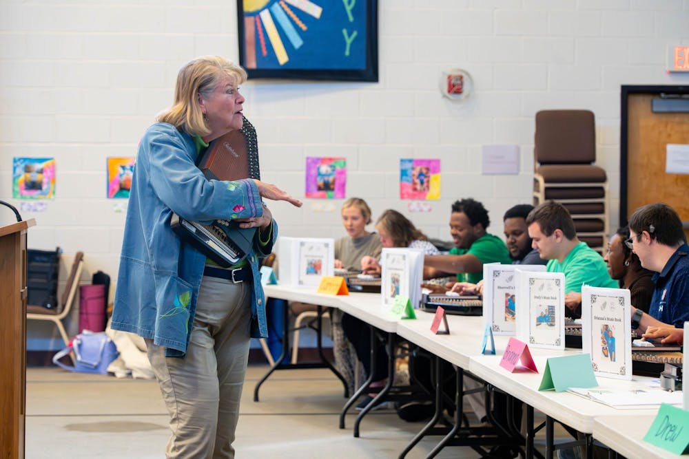 <p>Nancy Barry teaches students from BraveHeart Center for Place and Purpose how to use an autoharp. Contributed by Nancy Barry.</p>