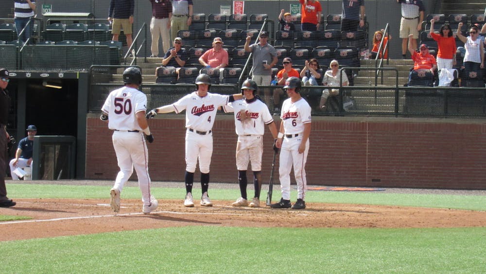 <p>Jake Wyandt (50) celebrates with teammates Brody Moore (4), Blake Rambusch (1), and Ryan Dyal (6) after hitting a home run against Rhode Island on March 6, 2022 at Plainsman Park in Auburn, Ala.</p>