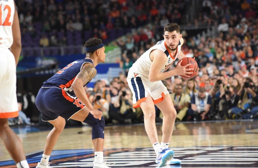 <p>Ty Jerome (12) picks up his dribble against Bryce Brown (2) during Auburn vs. Virginia in the Final Four on April 6, 2019, in Minneapolis, Minn.</p>