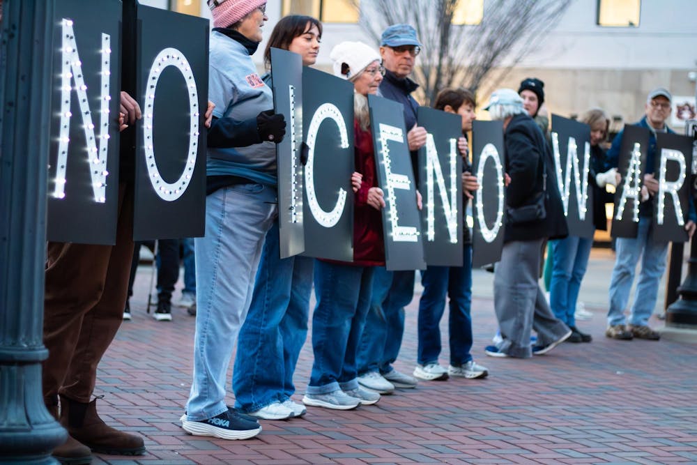 <p>Protestors hold up signs that spell out 'No Ice' and 'No War' during a protest against ICE, Immigration and Customs Enforcement, on Toomer's Corner in Auburn, Ala. on Jan. 21, 2026.</p>