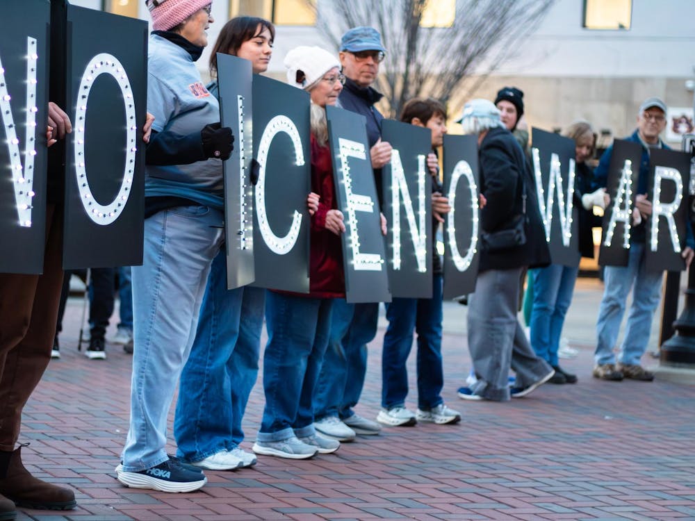 Protestors hold up signs that spell out 'No Ice' and 'No War' during a protest against ICE, Immigration and Customs Enforcement, on Toomer's Corner in Auburn, Ala. on Jan. 21, 2026.