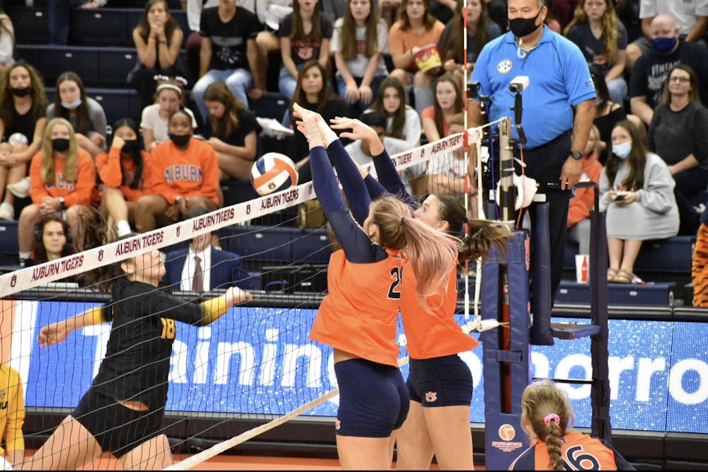 <p>Oct. 16, 2021; Auburn, AL, USA; Tatum Shipes (21, left) and Val Green (16, right) block a shot in a match between Auburn and Missouri in the Auburn Arena.</p>