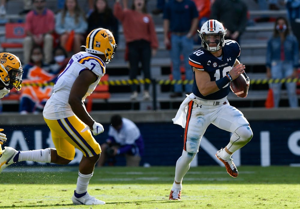 Oct 3, 2020; Auburn AL, USA; Bo Nix (10) rushes to his left for the first down during the game between Auburn and LSU at Jordan Hare Stadium. Mandatory Credit: Todd Van Emst/AU Athletics