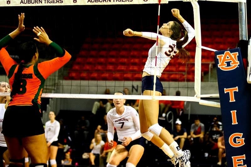 Macy Reece (#33) jumping high to hit the ball. (Kenny Moss | Photographer)