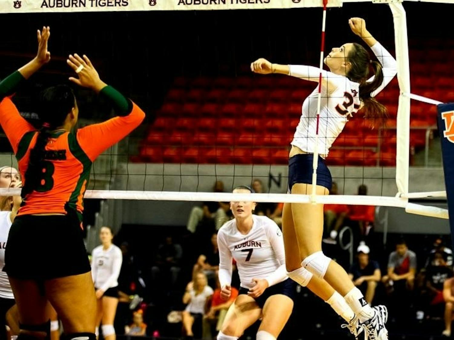 Macy Reece (#33) jumping high to hit the ball. (Kenny Moss | Photographer)