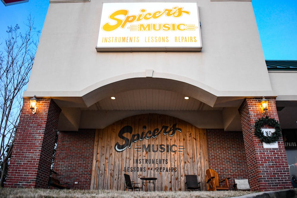 A holiday wreath hangs from the front entrance of Spicer's Music on Dec. 2, 2022, as the local music store is recognized for its 10th year anniversary.