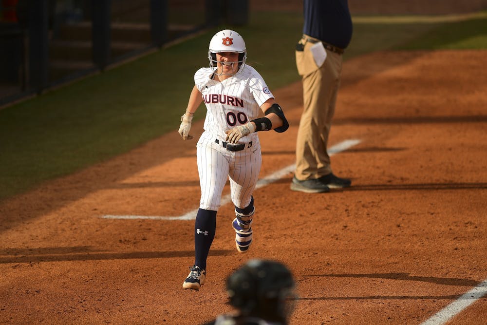 Feb 27, 2021; Auburn, AL, USA; Auburn Tigers Aspyn Godwin (00) reacts while running to home plate during the game between Auburn and IUPUI  at Jane B. Moore Field. Mandatory Credit: Shanna Lockwood/AU Athletics