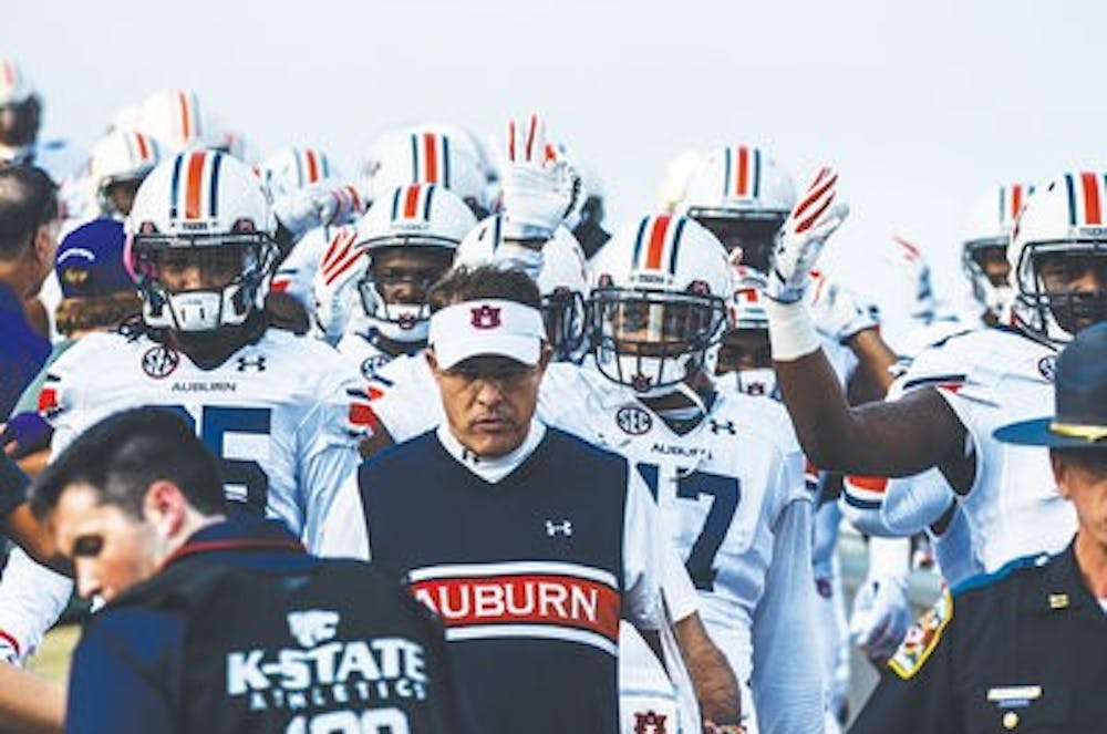Head coach Gus Malzahn leads Auburn to the field prior to a game at Kansas State on Sept. 18. (Raye May | Photo Editor)