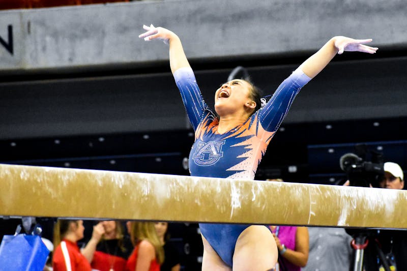 Suni Lee celebrates after finishing her beam routine which scored a 9.975 during the Second Round of the NCAA National Collegiate Gymnastics Tournament in the Neville Arena in Auburn, AL, on March 31, 2022.