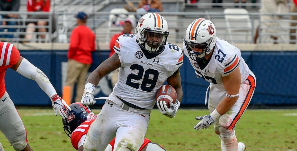 <p>JaTarvious Whitlow (28) runs the ball during Auburn football vs. Ole Miss on Oct. 20, 2018, in Oxford, Miss.</p>