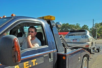 Rusty Hardy, driver for Auburn Express Towing, tows from more than 70 lots in town. (Tim Simpson / PHOTO STAFF)