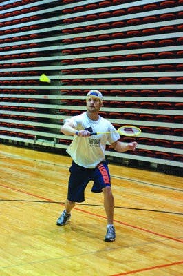 Clint Jarvis, junior in business administration, sends the birdie over the net during the badminton club team practice Tuesday in the Student Act. (Philip Smith/ Photo Staff )