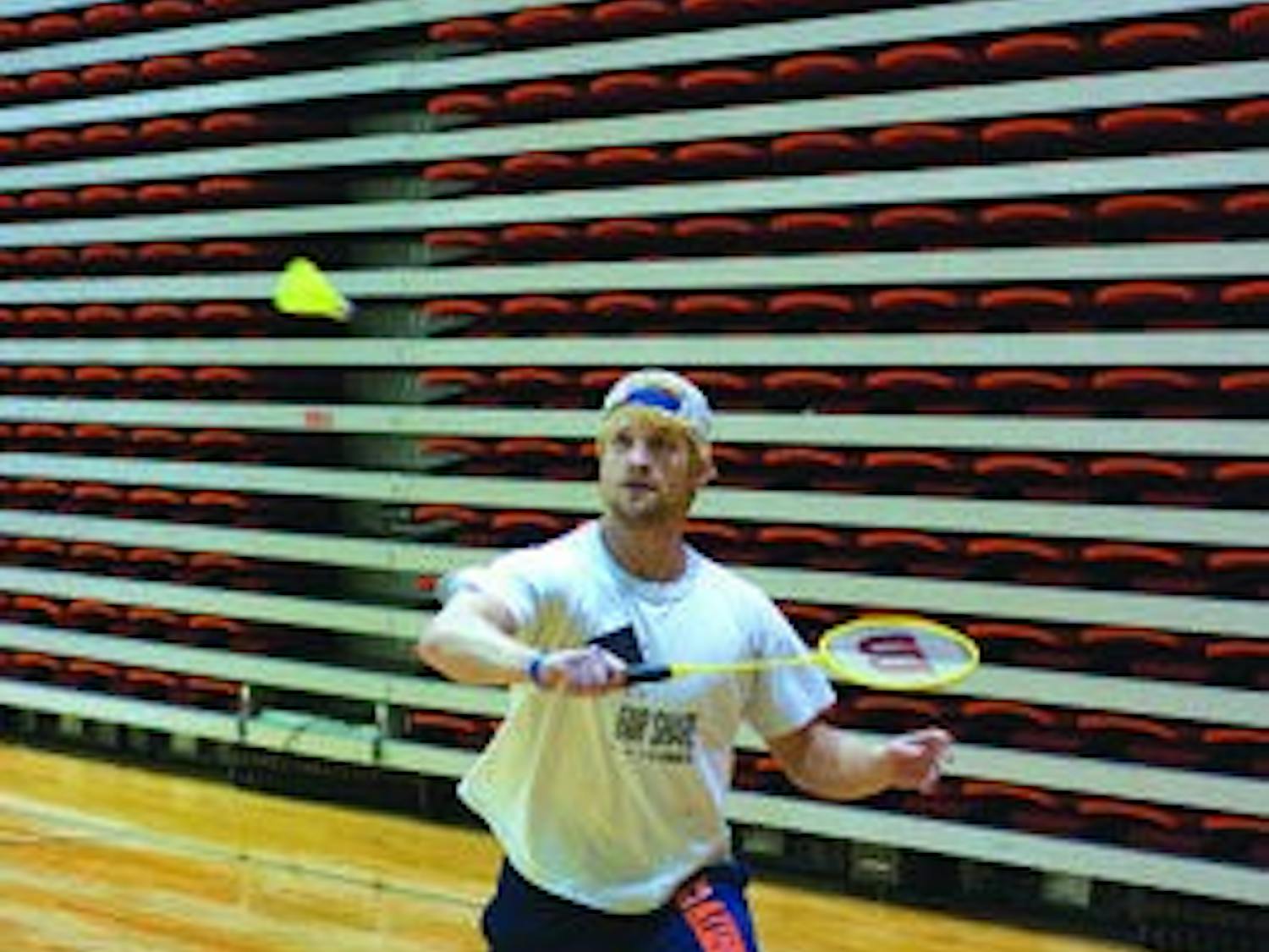 Clint Jarvis, junior in business administration, sends the birdie over the net during the badminton club team practice Tuesday in the Student Act. (Philip Smith/ Photo Staff )