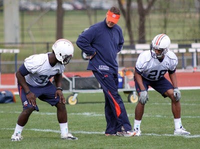 Gene Chizik instructs true freshman cornerback Jonathan Rose in drills during the first spring practice. (Emily Adams / Photo Editor)