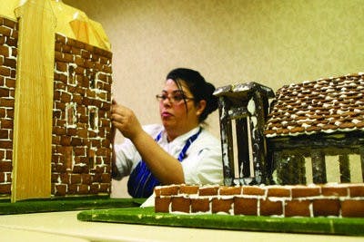 Chef Adelle Bonilla leads a team to create an Auburn gingerbread village masterpiece each year. Last year she used 90 eggs, 80 pounds of flour, 30 pounds of sugar, 7 pounds of molasses and 5 pounds of ground sugar, cinnamon and nutmeg to finish the job. (Rebecca Croomes / ASSISTANT PHOTO EDITOR)