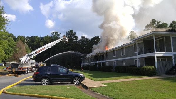 Firefighters work to put out a fire at Village West Apartments. 