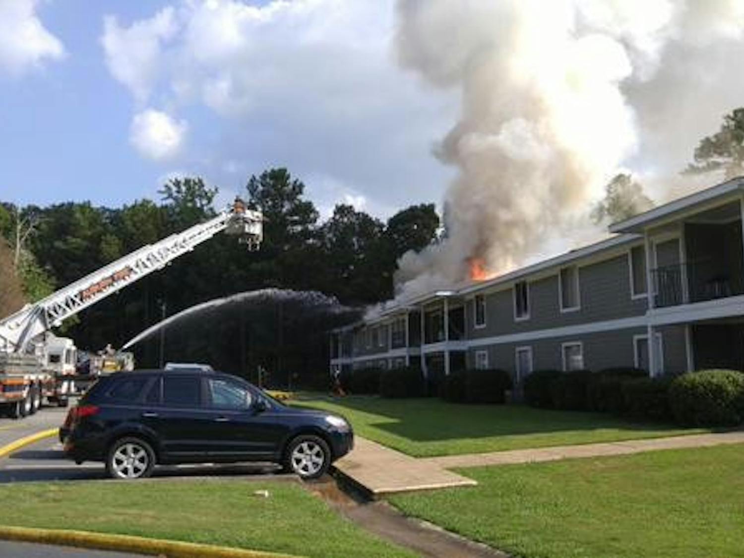 Firefighters work to put out a fire at Village West Apartments. 