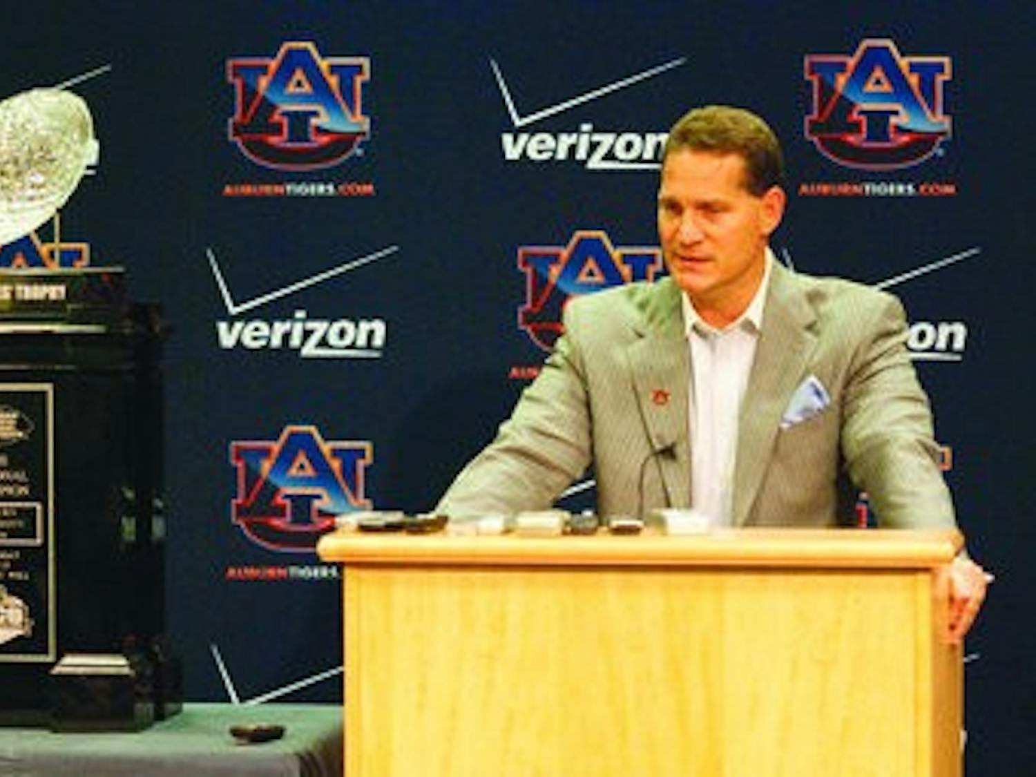 Head coach Gene Chizik stands next to the BCS Championship trophy as he discusses signing day commitments. (Emily Adams / Photo Editor)