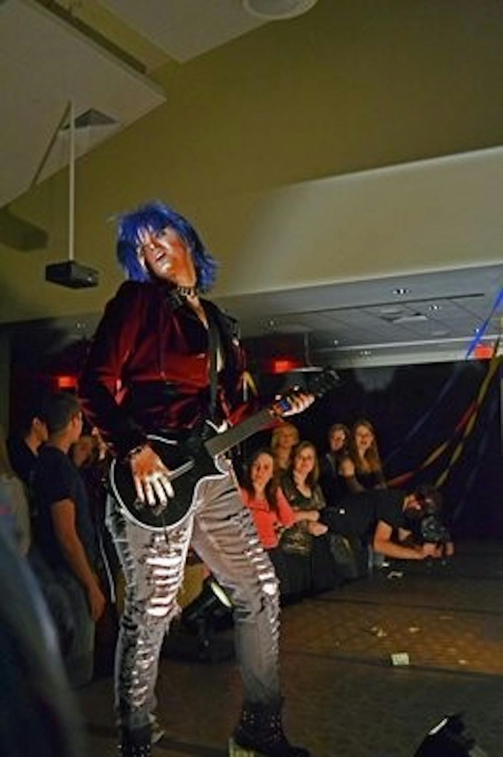 Sky A performs Nickleback's "Rockstar" with a Guitar Hero controller at this year's What-a-Drag! event Friday, March 1. (Raye May / PHOTO EDITOR)