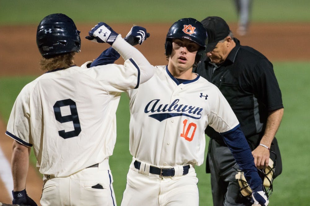 Edouard Julien (10) celebrates a home run with Luke Jarvis (9)&nbsp;during Auburn baseball vs. Missouri at Plainsman Park in Auburn, Ala. on Friday, March 30, 2018.