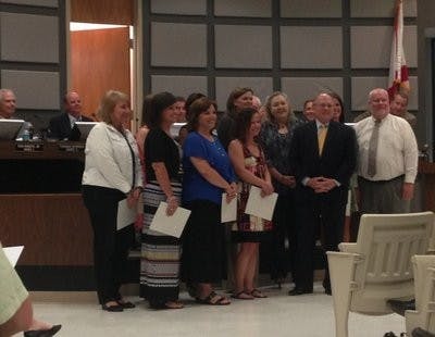 From left to right: Leah Shope, Auburn Early Education Center; Sandra Beisel, Cary Woods Elementary School; Sherri Shiver, Dean Road Elementary School; Montasha Preston, Ogletree Elementary School; Amber DeBlanc, Richland Elementary School; Dotsy Carter, Wrights Mill Road Elementary School; Heather Taylor, Yarbrough Elementary School; Jenny Ferguson, Drake Middle School; Tabitha Geiger, Auburn Junior High School; Matt York, Auburn High School receive their awards in front of the council. (Chandler Jones / COMMUNITY REPORTER)