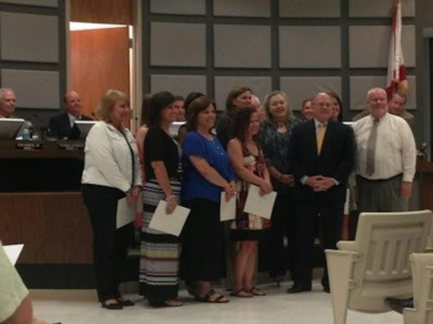 From left to right: Leah Shope, Auburn Early Education Center; Sandra Beisel, Cary Woods Elementary School; Sherri Shiver, Dean Road Elementary School; Montasha Preston, Ogletree Elementary School; Amber DeBlanc, Richland Elementary School; Dotsy Carter, Wrights Mill Road Elementary School; Heather Taylor, Yarbrough Elementary School; Jenny Ferguson, Drake Middle School; Tabitha Geiger, Auburn Junior High School; Matt York, Auburn High School receive their awards in front of the council. (Chandler Jones / COMMUNITY REPORTER)
