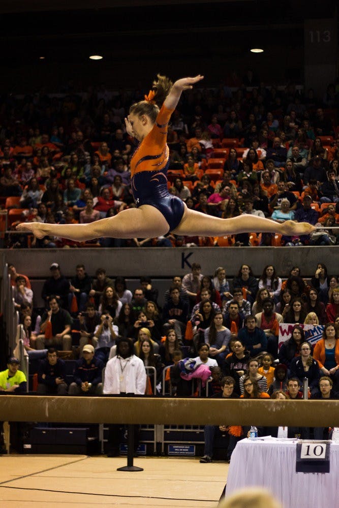 Auburn gymnast Megan Walker does a leap on the beam on February 14, 2014. Jenna Burgess / PHOTOGRAPHER