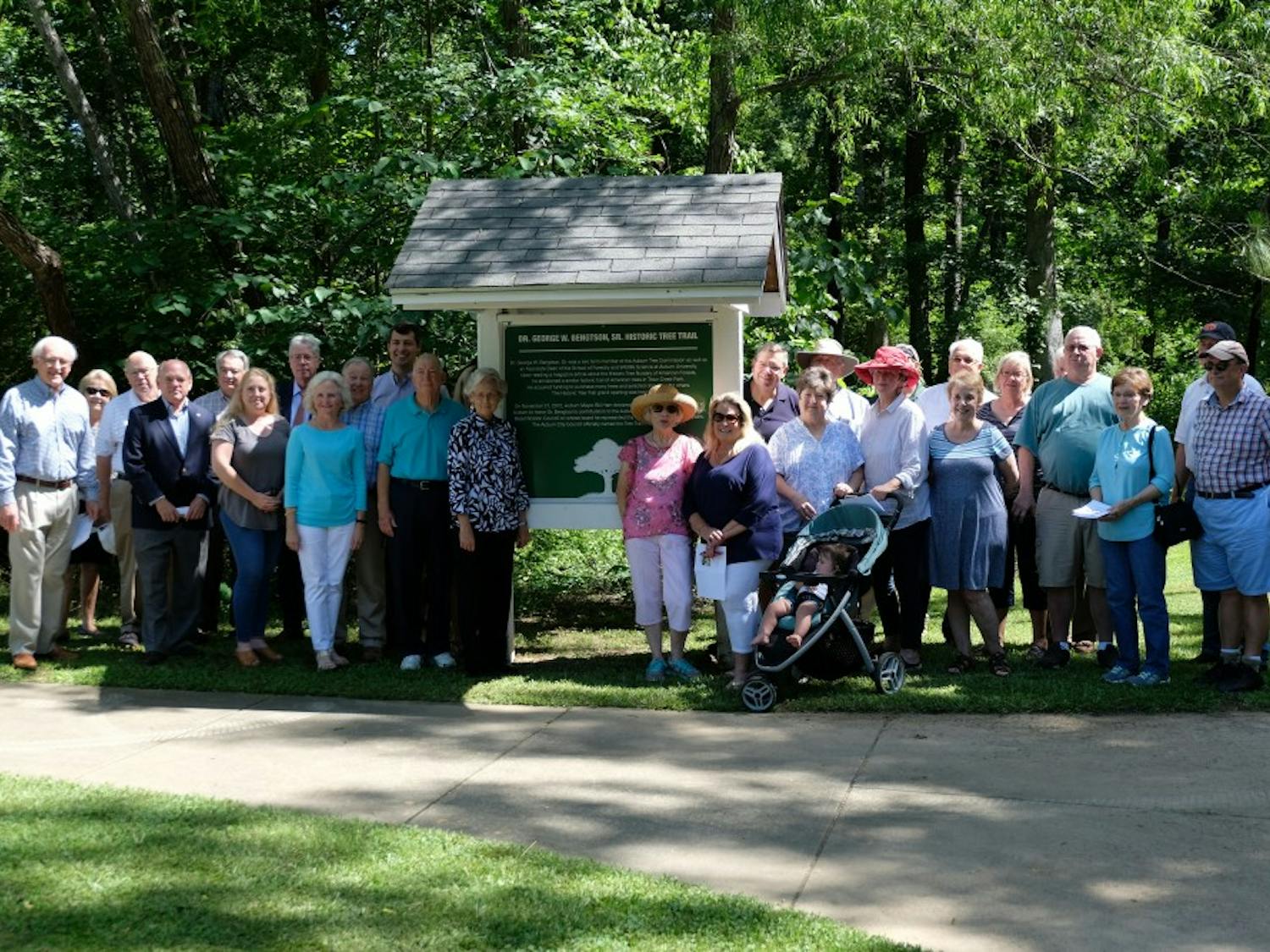 Group poses for photo at the George Bengston Tree Trail Dedication