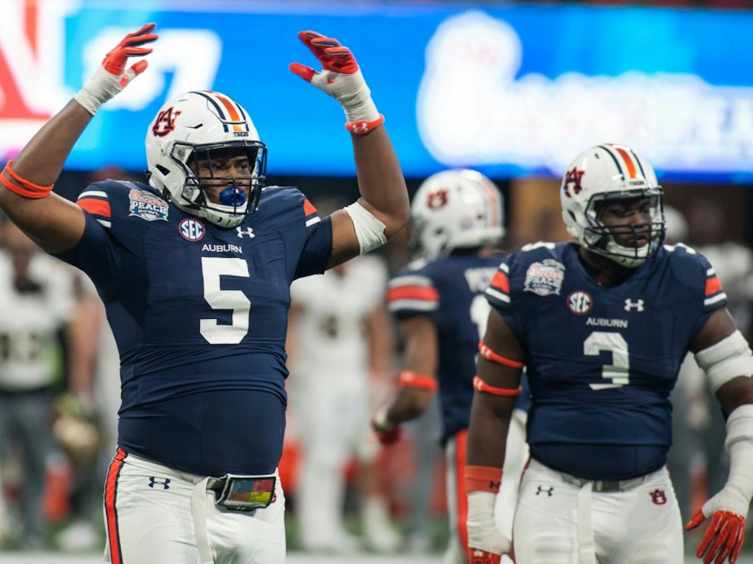 Derrick Brown (5) gets the Auburn crowd up and loud in the second half. Auburn vs UCF on Monday, Jan. 1 in Atlanta, Ga.