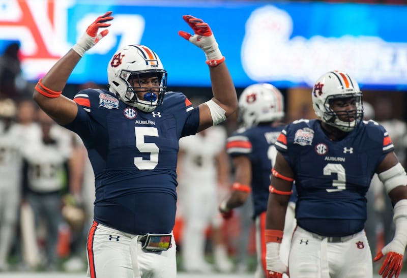 Derrick Brown (5) gets the Auburn crowd up and loud in the second half. Auburn vs UCF on Monday, Jan. 1 in Atlanta, Ga.