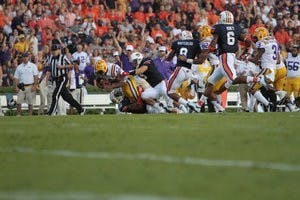 The Auburn Tigers take down Michael Ford, running back for LSU. (Rebecca Croomes / PHOTO EDITOR)