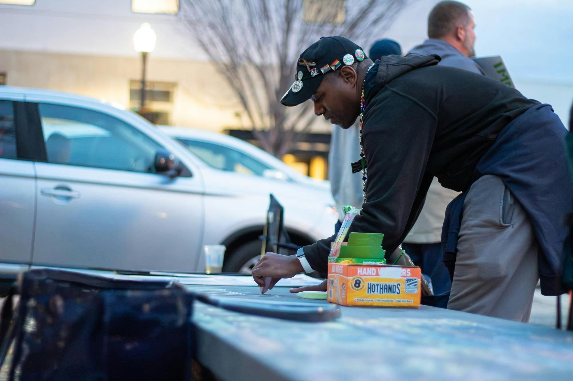 A protestor attending the ICE, Immigration and Customs Enforcement, protest on Toomer's Corner in Auburn, Ala. writes messages in chalk as part of the protest on Jan. 21, 2026. 
