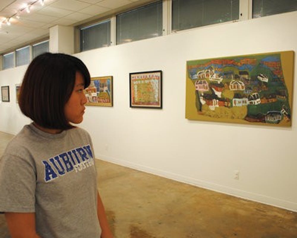 Minhee Park, sophomore at Auburn High School, admires works by John Miller Gorrie. (Maria Iampietro / Associate Photo Editor)