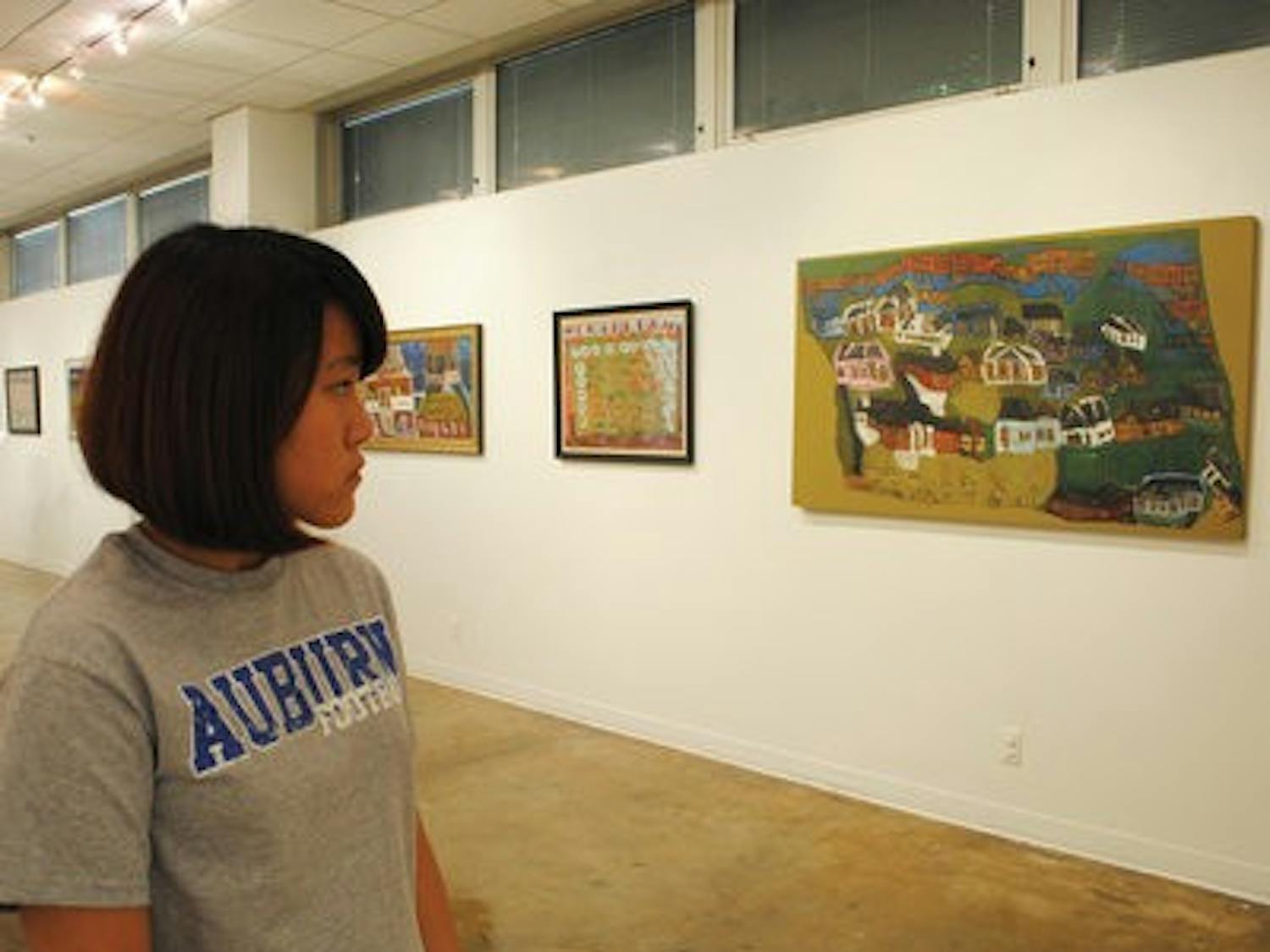 Minhee Park, sophomore at Auburn High School, admires works by John Miller Gorrie. (Maria Iampietro / Associate Photo Editor)