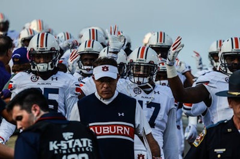 Gus Malzahn and the Auburn football team walking into the stadium. (Raye May | Photo Editor)